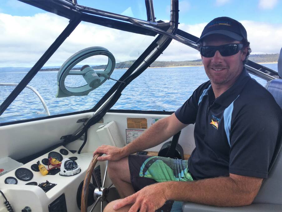 SKIPPER: Freycinet Adventures' Nathan Carins in his aqua taxi, which he uses to take clients to Picnic Island and around the peninsula.