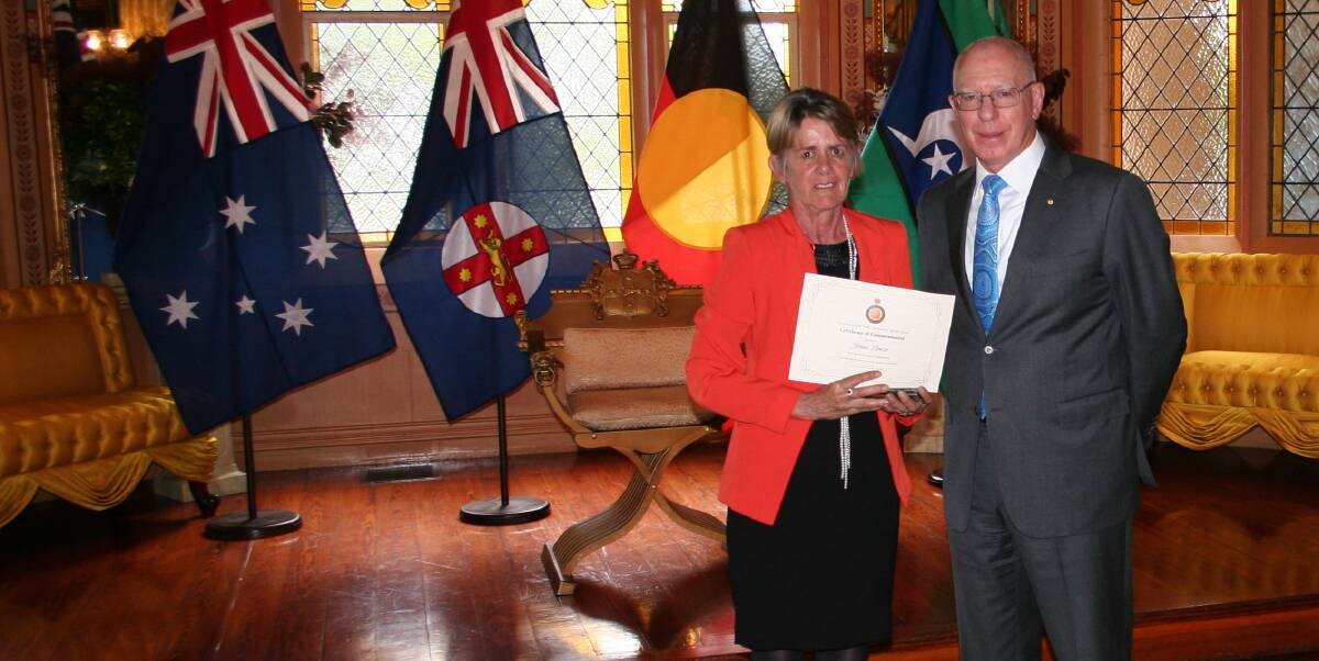 Jesse Price's mother Joanne receiving the citation and trophy from NSW Governor David Hurley.