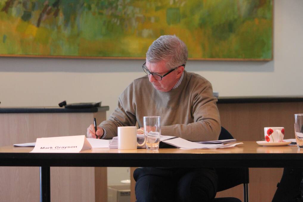 Joint Regional Planning Panelist Mark Grayson taking notes during the hearing in Goulburn in July. 
