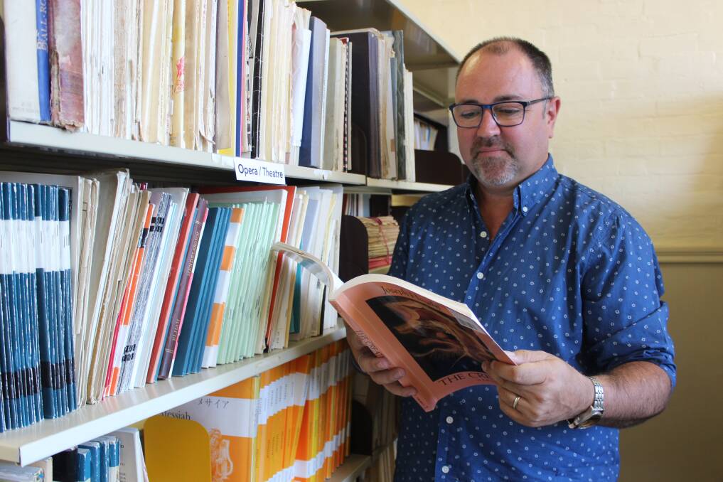 NEW LIBRARY: Goulburn Regional Conservatorium director Paul Scott-Williams flicks through one of the many music scores on display at the new music library. Photo: Mariam Koslay. 