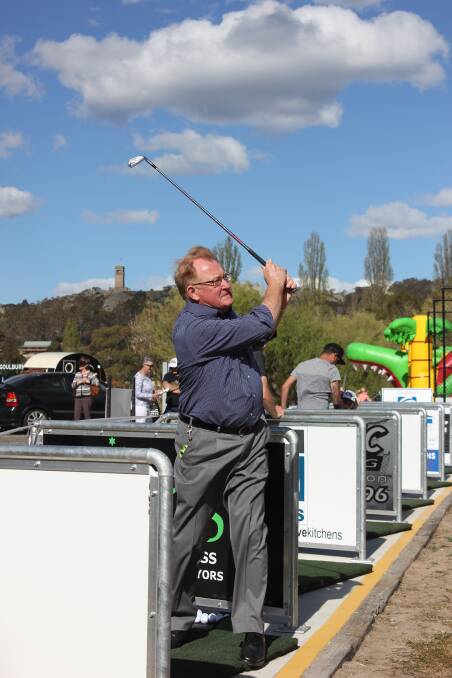 SWING: Goulburn Mulwaree Council Mayor Bob Kirk takes a few hits at the new driving range in Goulburn, which was unveiled on Friday. Photo David Cole. 