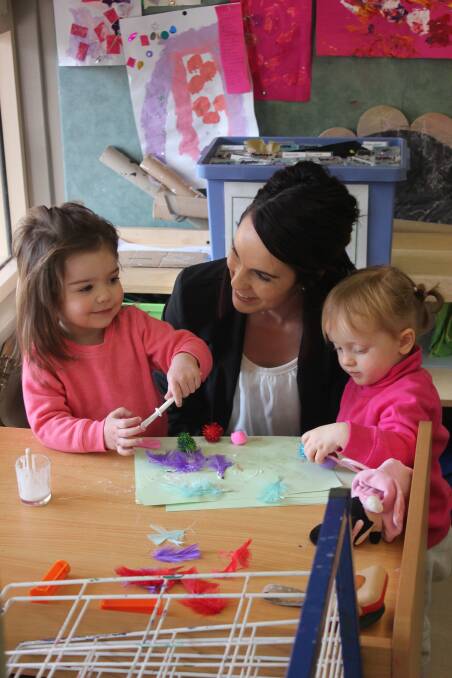 MILESTONE: Anglicare’s Early Childhood Centre at Goulburn Illawarra TAFE director Ashley Sturgiss with Scarlett and Desira. Photo: Mariam Koslay
