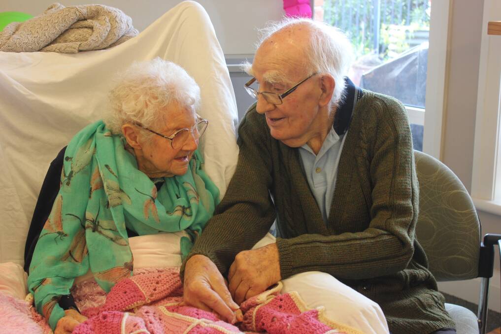 SPECIAL: Ken Biddle holds his wife Hilma's hand during celebrations for her 102 birthday at Warrigal on Tuesday morning. About 35 people attended her birthday party. All photos: Mariam Koslay. 