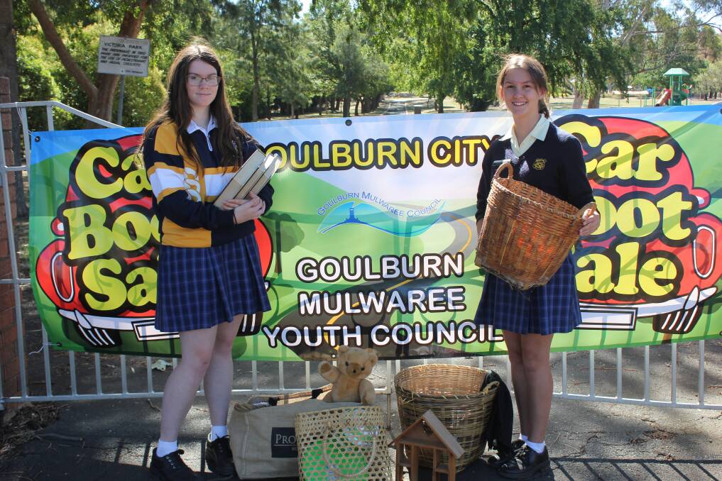 CLEAN UP: Goulburn Mulwaree youth council mayor Maggie Hargan,17, and deputy mayor Charlotte Hargan, 13, get ready for the 'car boot' sale at Victoria Park. 