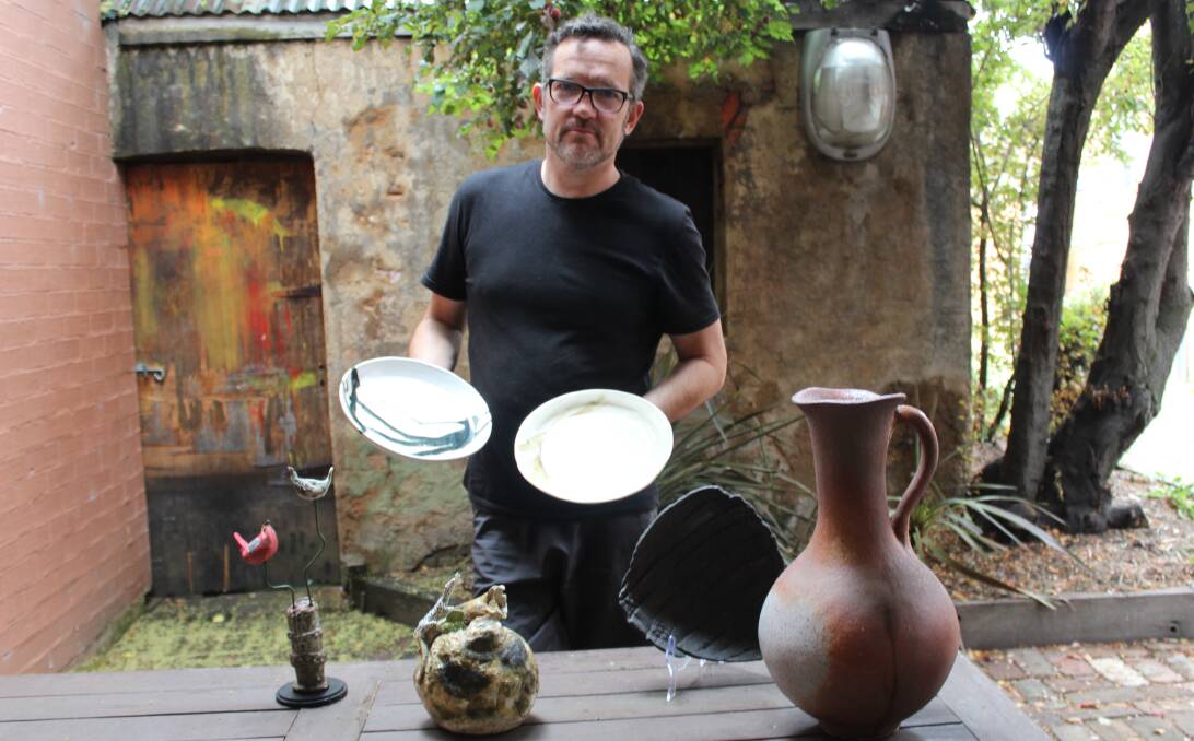 NEW BEGINNINGS: Owner and chef from 98 Chairs, Steve Walker, stands among a variety of local ceramic products currently on display and created by Goulburn artists in the lead-up to the summer season. Photo: Mariam Koslay