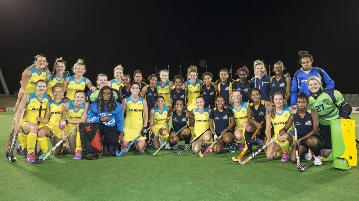 TOGETHER: Australia's Hockeyroos mixed with the Papua New Guinea team who they Australian's defeated soundly earlier in the Oceania series. Captain Emily Smith from Crookwell (centre front) with an opponent either side. Photo: Hockey Australia