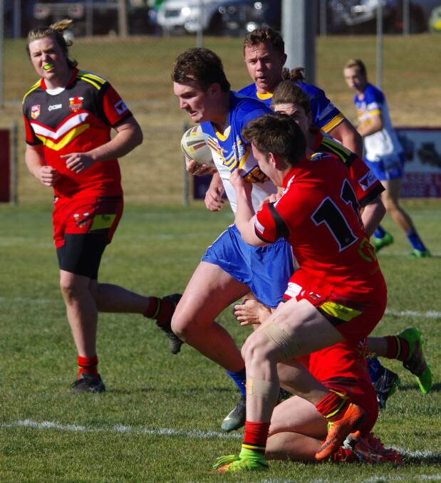 CHARGING: Tom Hazelwood fends off his Gungahlin Bulls opponent as he charges forward in the recent under 18s game at the Workers Arena. Photo: Darryl Fernance