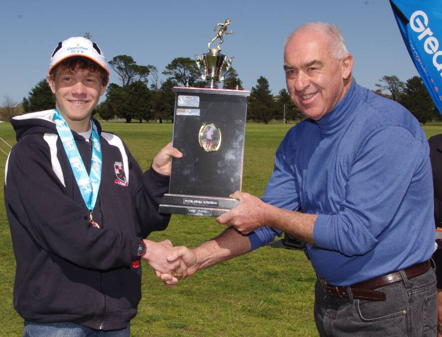 Jonathan Moore receives the Peter Oberg Memorial Trophy for the first local 10km runner home, Peter's father, Leon Oberg.