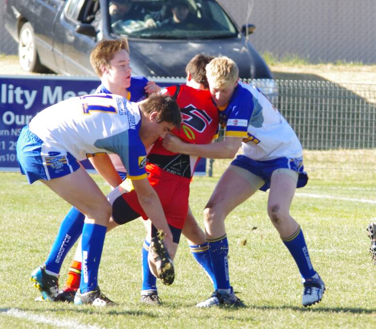 WRAPPED UP: Tom Menzies, Issac Lanham and Tommy Whittaker bring down a Gungahlin Bull during the recent under 18s game at the Workers Arena. Photo: Darryl Fernance