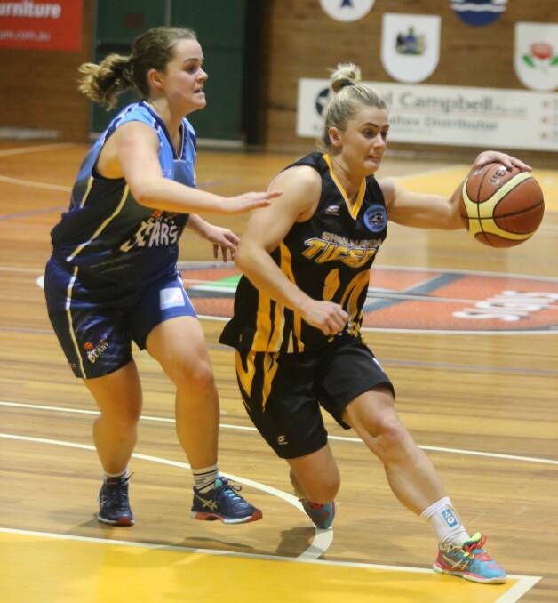 DEFENDING: Goulburn Bears' Jasmine Huntley attempts to shut down a scoring opportunity for  Shoalhaven Tigers'  Olivia Patterson on Saturday at the Tigers' Den. Photo: Robert Crawford, South Coast Register