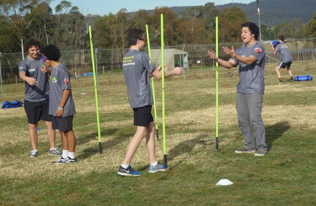 TRUST: Mulwaree High Aspire Program participants Danny Fraietta, Anthony Horvath, Max Bricknell and Andrew Skidmore undertaking a  trust, self-confidence and teamwork exercise. Photo: Ben Stephenson
