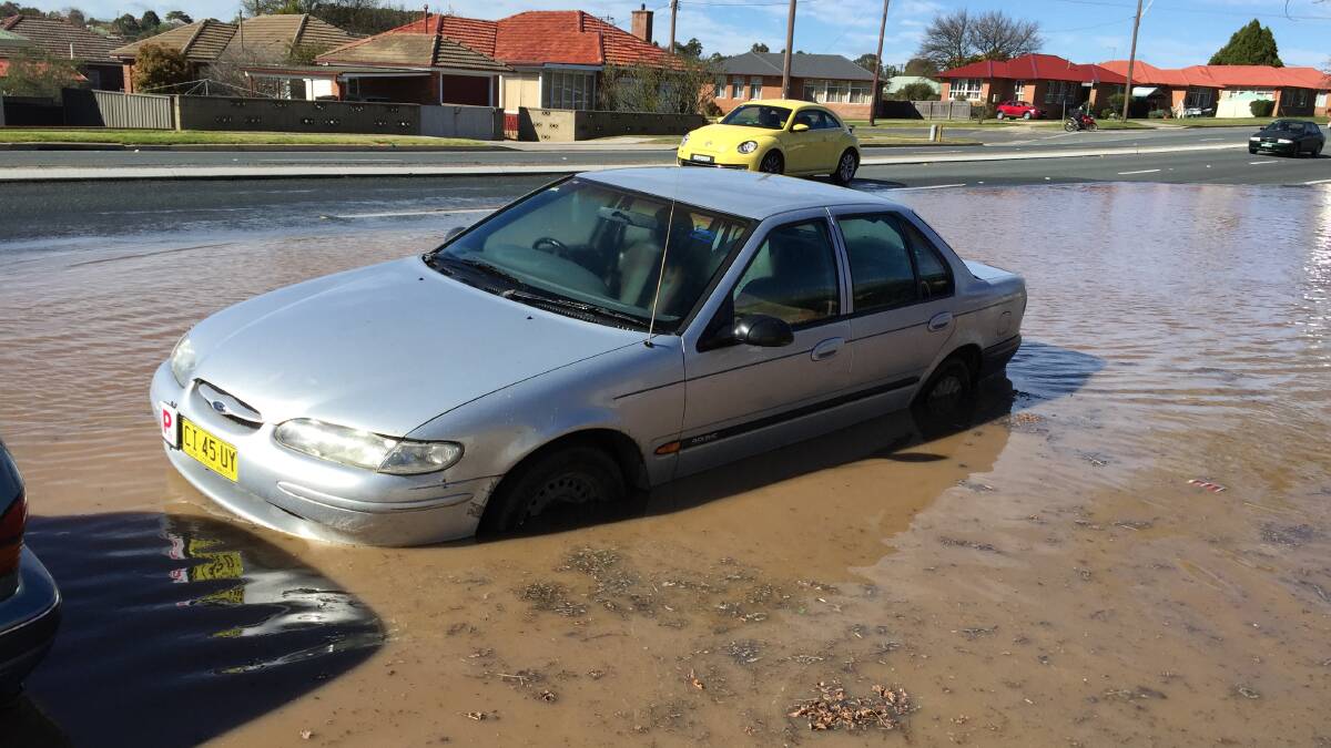 One of the cars parked in the flooded area of Hume St. Photo: Darryl Fernance