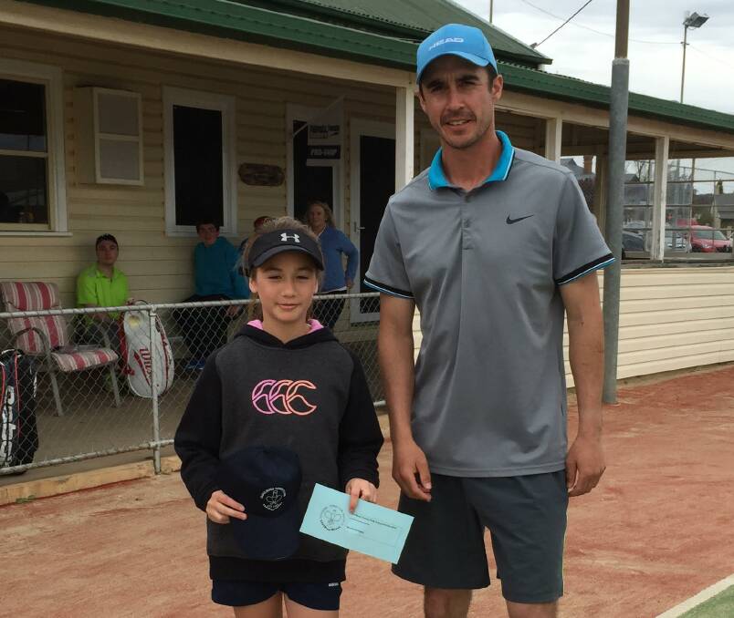 WINNERS: B grade Women's Singles Champion Chantelle Barling receives her prize from the Men's Singles A Grade Champion, her coach, Dave Ridland. Photo: supplied.
