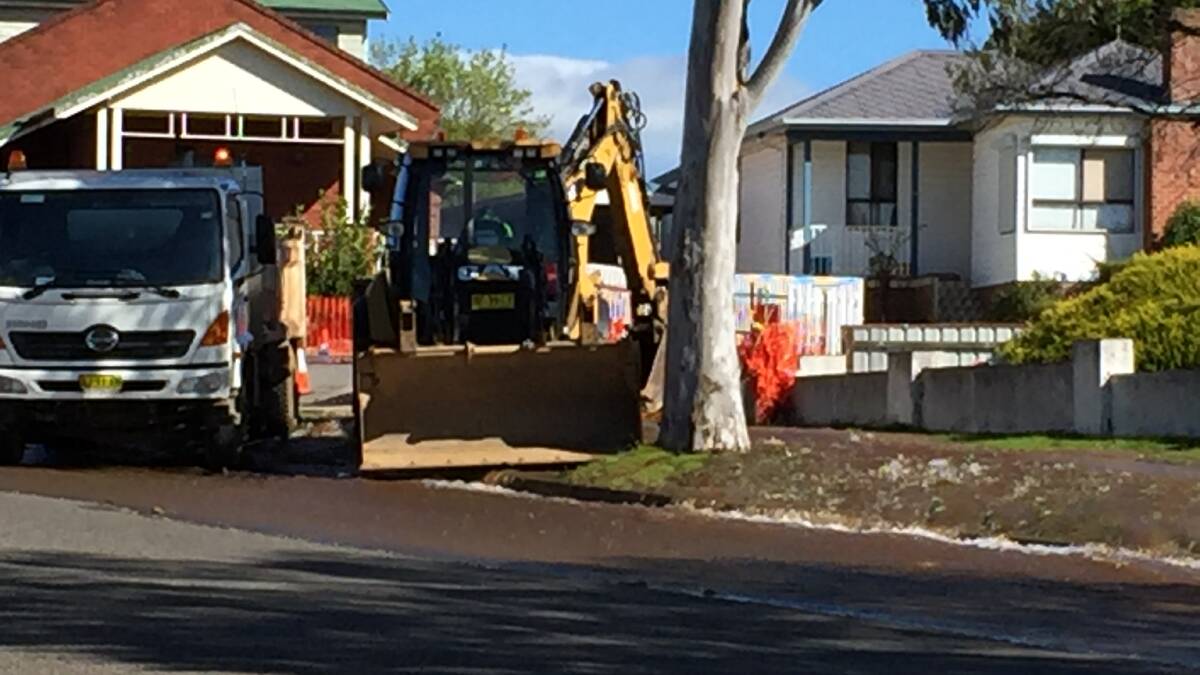A backhoe loader on the corner of Mary and Robinson St at the source of the flooding. Photo Darryl Fernance
