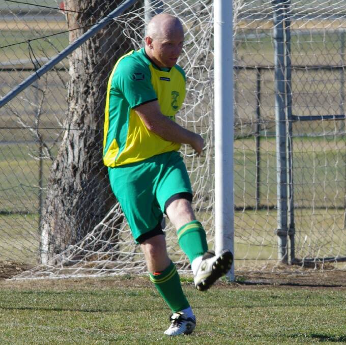 BOOT IN: Wollondilly FC trivia buff and defender Rick Tozer kicking clear.