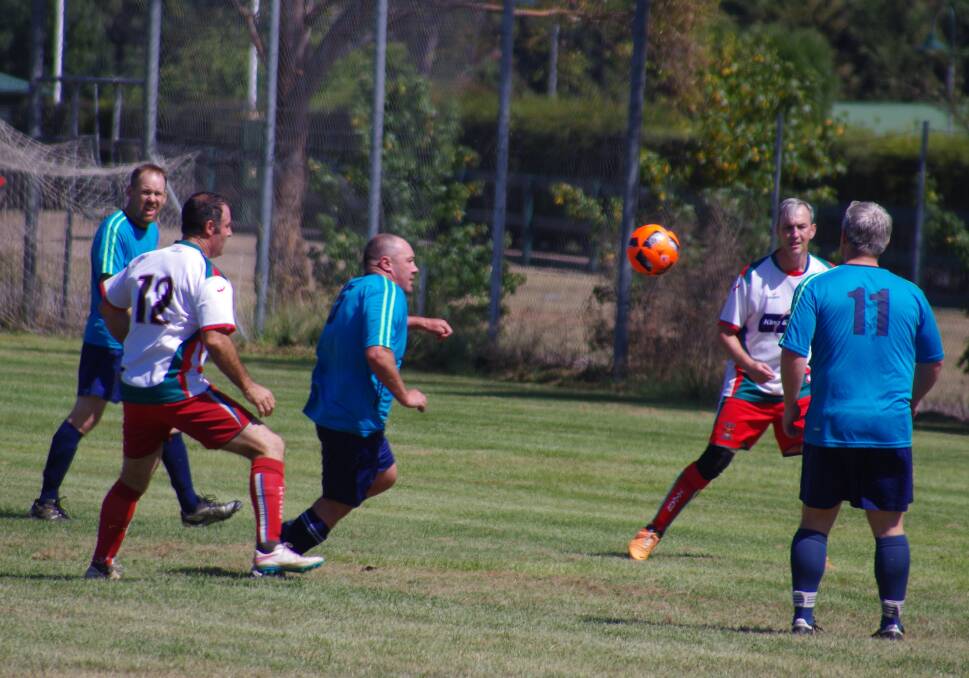 COMPETING: Goulburn (in the blue) taking on Tahmoor in the over 35s soccer tournament in 2017. Photo: Darryl Fernance