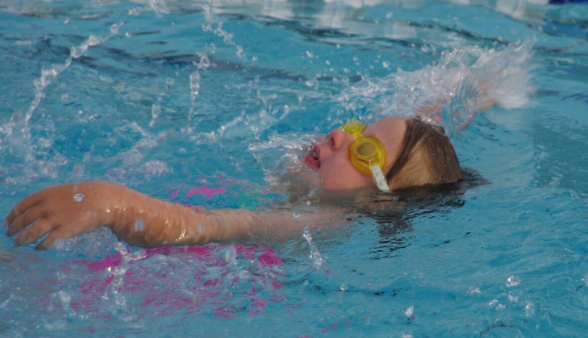 YOUNG: Abigail Apps, one of Goulburn Swimming Club's youngest members, competing in the 25 metre backstroke event on Friday night in preparation for the development meet. Photo: Darryl Fernance