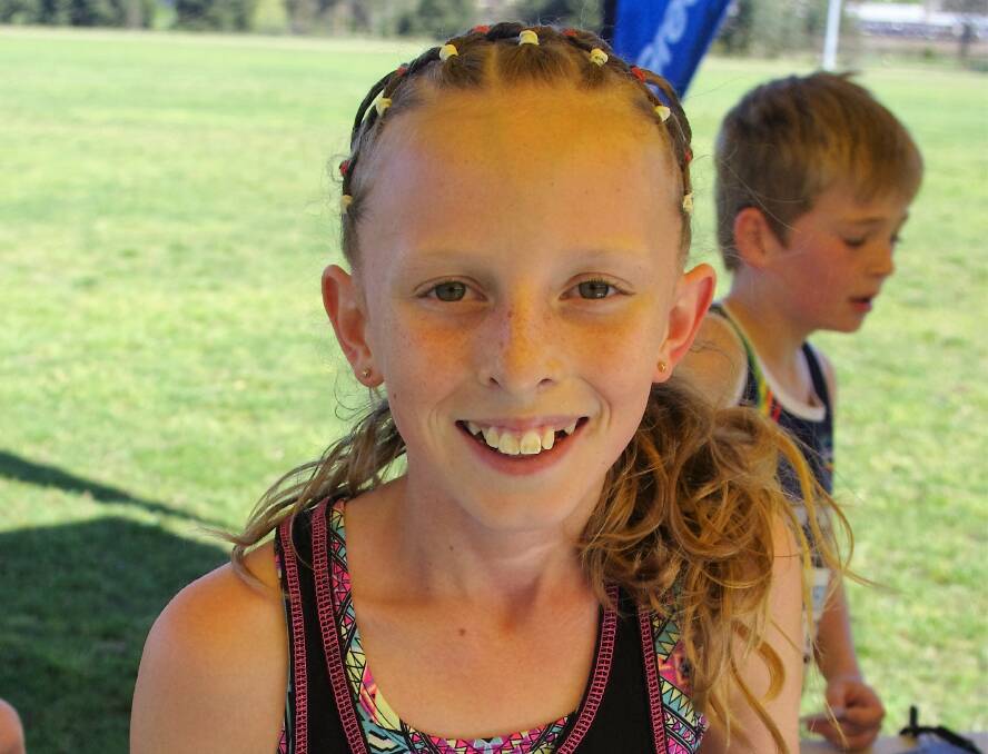 Ten-year-old Jessica Hassan winner of the 2km junior fun run just after she registered her details with the Running NSW official recorder.