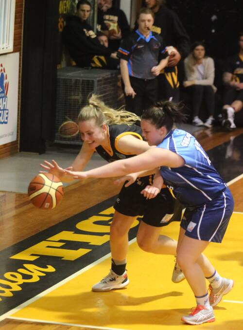 GUARDING: Goulburn Bears' Courtney Edwards does her job under the basket, keeping Shoalhaven from getting a shot up. Photo: Robert Crawford South Coast Register.
