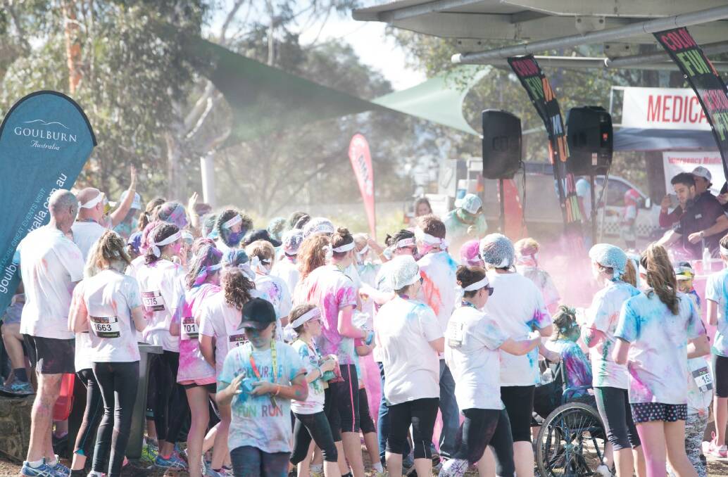 COLOUR FUN: Colour powder bursts forth as runners congregate at the stage area in Victoria Park  during last year's Colour Me Fun Run. Photo: supplied