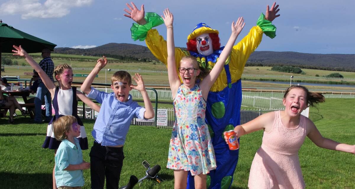 Fun Day: Kidding around with a friendly clown on the grass slope at the Goulburn and District Racing Club's 2015 Kids Day Out. Photo: Darryl Fernance