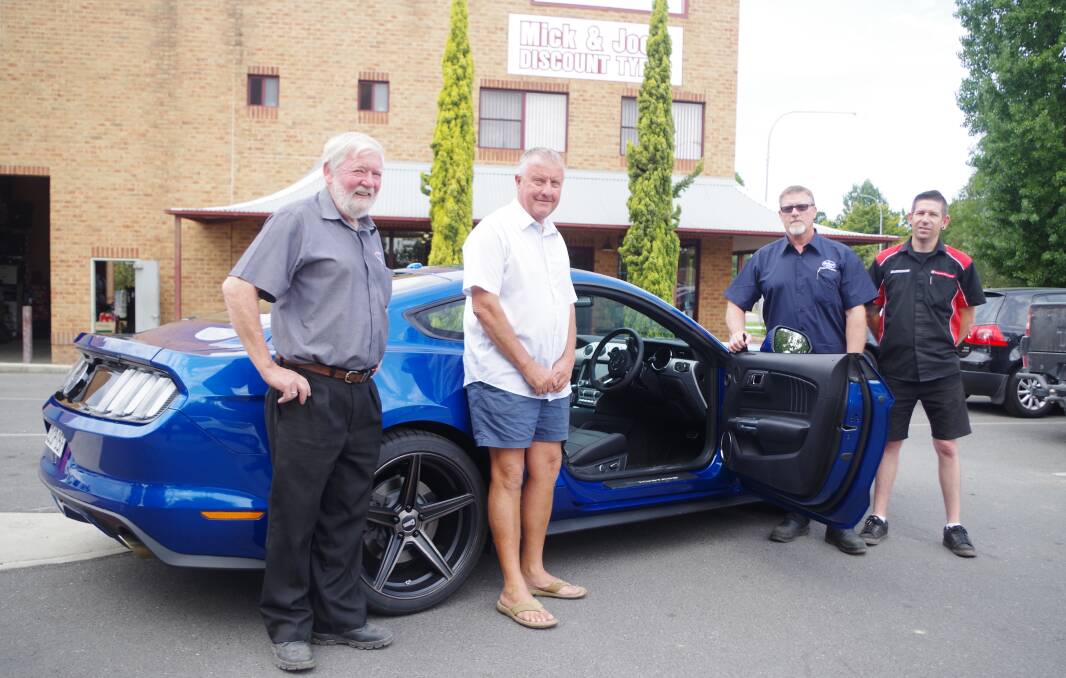 COOPER PRIZE: Mick and Joes Discount Tyres director Brian McAlister with winner Peter Stephenson, Cooper Tires Accountys manager Mark Pullan and Mick and Joes manager Damian McAlister. with the Ford Mustang GT complete with Cooper tyres. Photo: Darryl Fernance