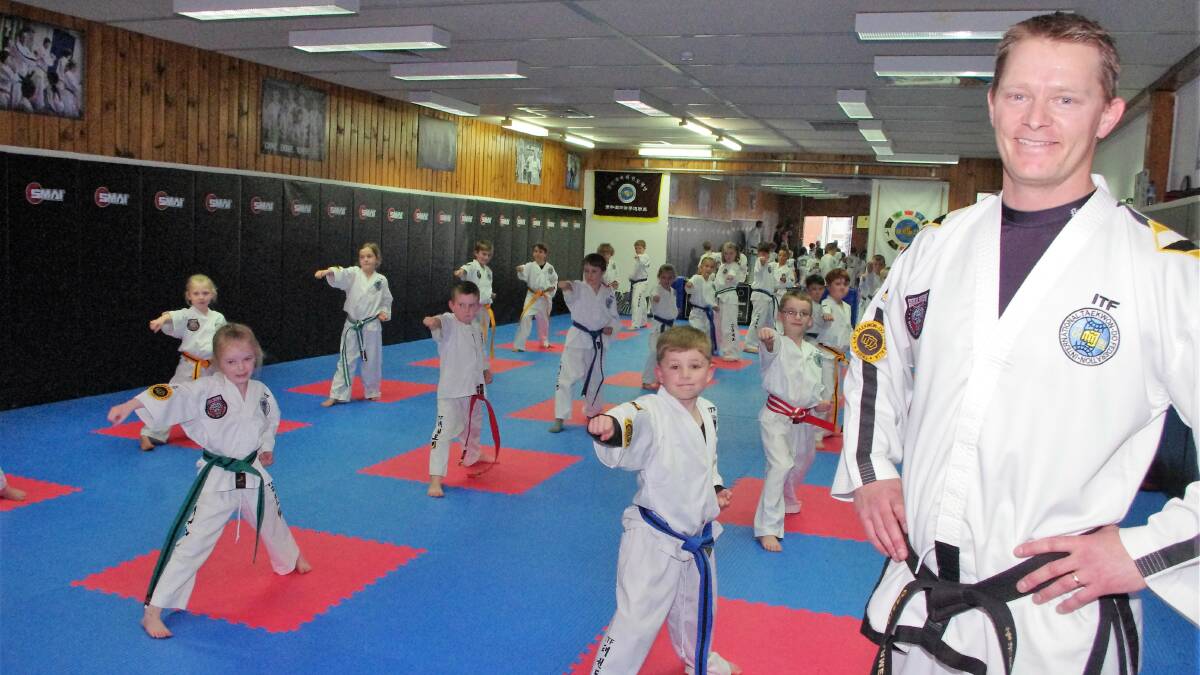 NEW CENTRE: Craig Harmer , principal of Goulburn Martial Arts Academy with some of his taekwondo classes in the new upstairs in Clifford St. Photo: Darryl Fernance