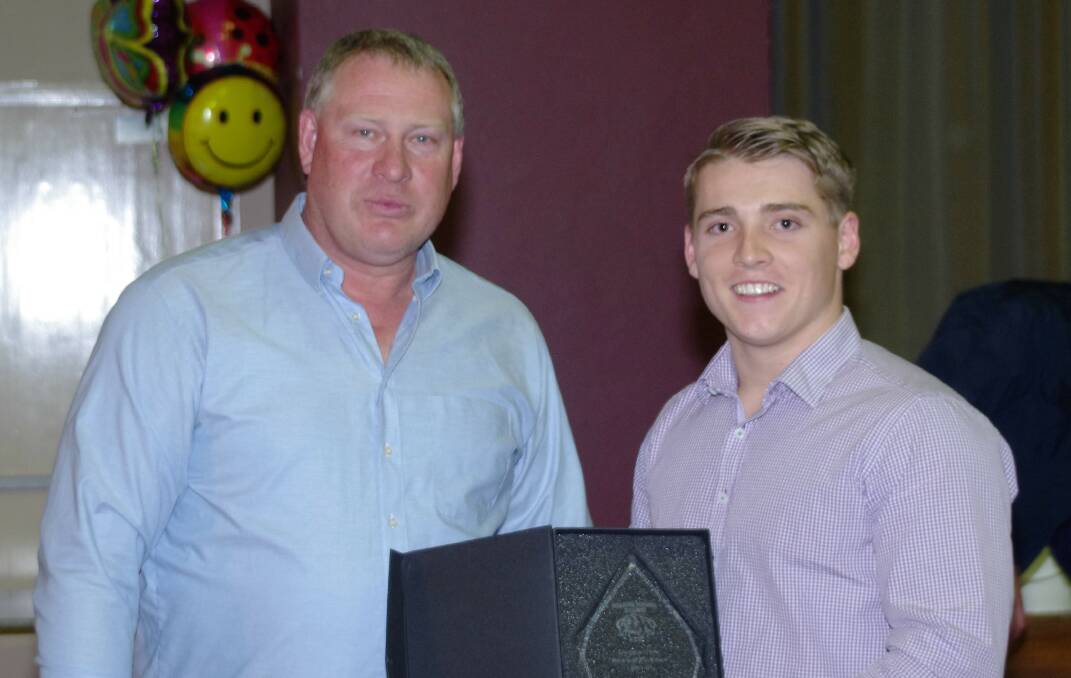 Bulldogs sponsor Scott Gann presented Charlie Reardon with the Best and Fairest under 18s player award during the Bulldogs' dinner.