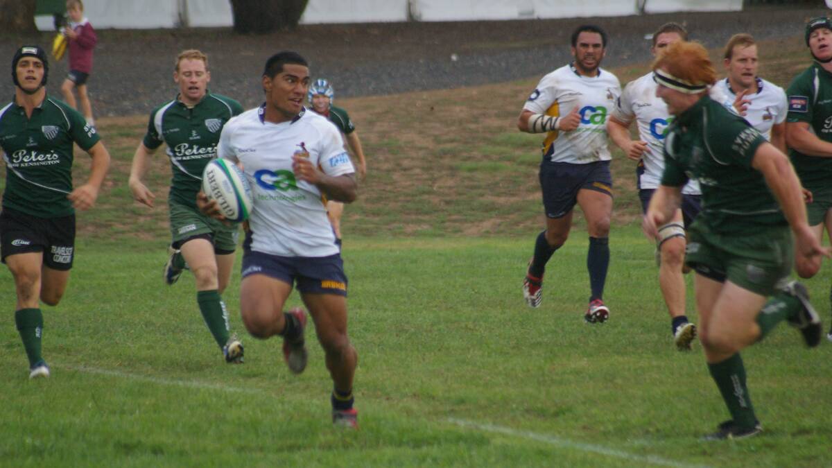 BREAK: A Brumbies Runner player makes a break as a Randwick defender looms at Poidevin Oval in 2011.Photo: Chris Gordon