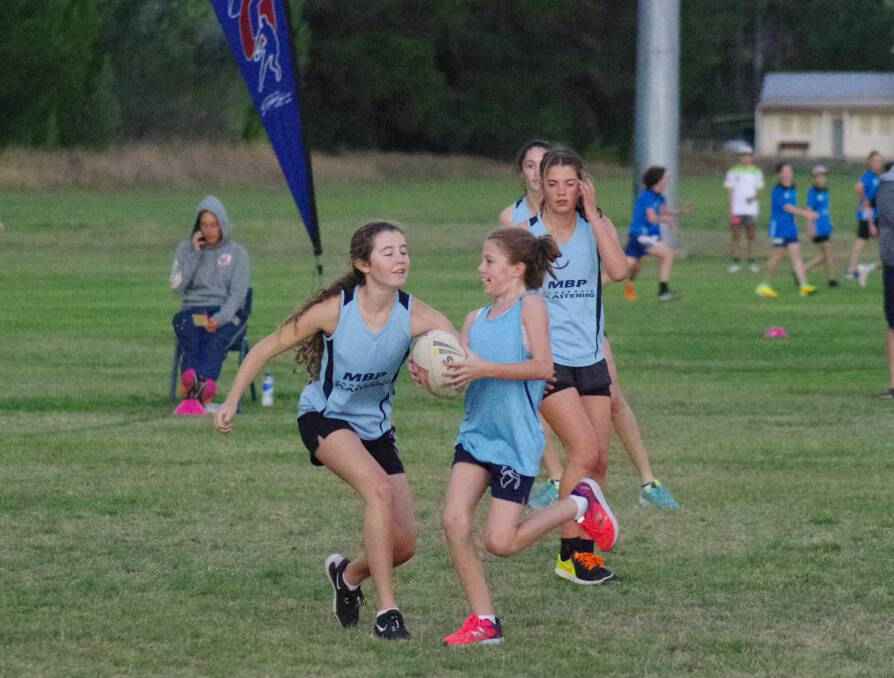 GAME ON: Mawbrook Maniacs' Holly Spillane gets the touch on Pink Panther Tilly Stewart during thir under 14s girls grand final. Photo: Darryl Fernance