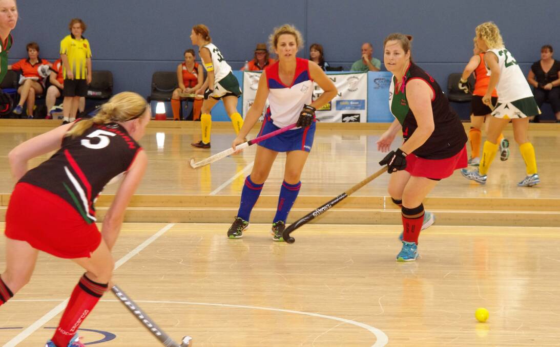 STICKS CLASH: Action from the Goulburn 1 versus Parkes 1 NSW Masters Indoor Hockey Championships in 2017. Photo: Darryl Fernance