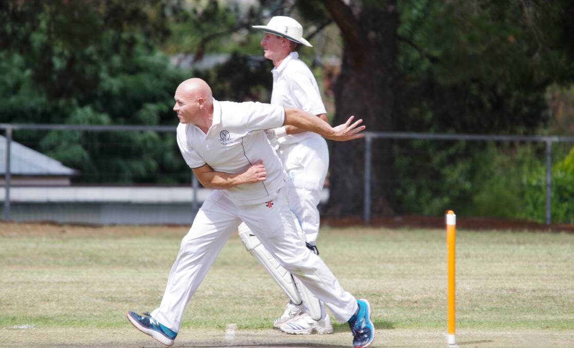 BOWLING: Adam Rudd bowling to Hamad Farooq with Russell Mills, who would also make over 100 on the Trinity two turf, off strike. Photo: Darryl Fernance