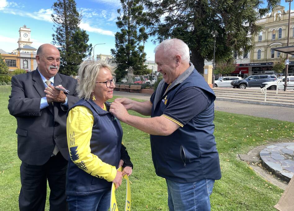 Goulburn Rotary Club president, Steve Ruddell, surprised the council's road safety officer, Tracey Norberg, with a Paul Harris Fellowship on Wednesday, April 24. Mayor Peter Walker watches on. Picture by Louise Thrower.