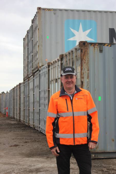 Former Chicago Freight Rail Services manager, Mick Cooper with log-filled containers at the Braidwood Road site in July, 2016.