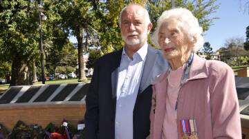 Helen Clark was a signals operator for the Women's Auxiliary Australian Air Force during World War Two and later became a campaigner for veterans' entitlements. She is with son, Peter, at Thursday's Anzac Day commemorations in Belmore Park. Picture by Louise Thrower.