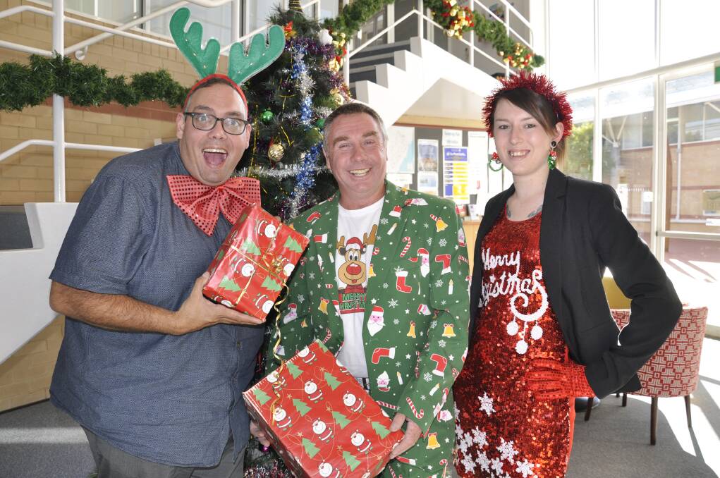 CHEER: Deputy Mayor Alf Walker, Cr Andrew Banfield and Leah Ferrara jumped into the Christmas spirit at Tuesday night's meeting. Photo: Louise Thrower.  
