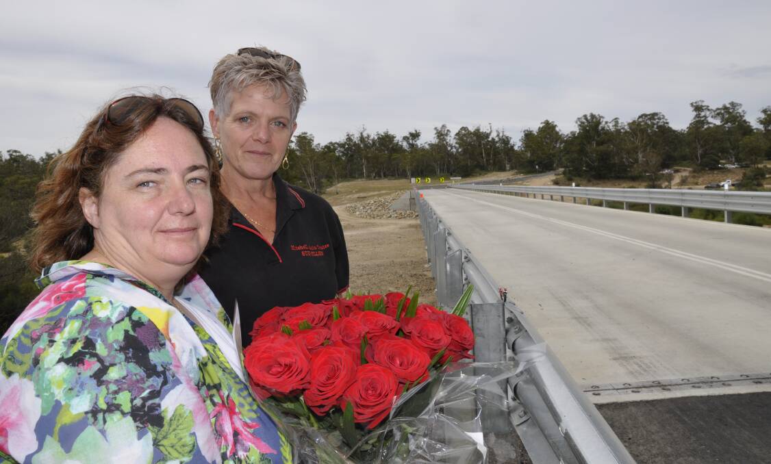 IN MEMORY: Mr Hughes' partner Melissa Pearce with sister-in-law, Sue-Ellen Hughes at Oallen Ford bridge's official opening in December, 2015. The bridge was opened to the public on September 10 that year. The pair are standing at the guard rail Mr Hughes' struck after his bike allegedly hit a pothole. 