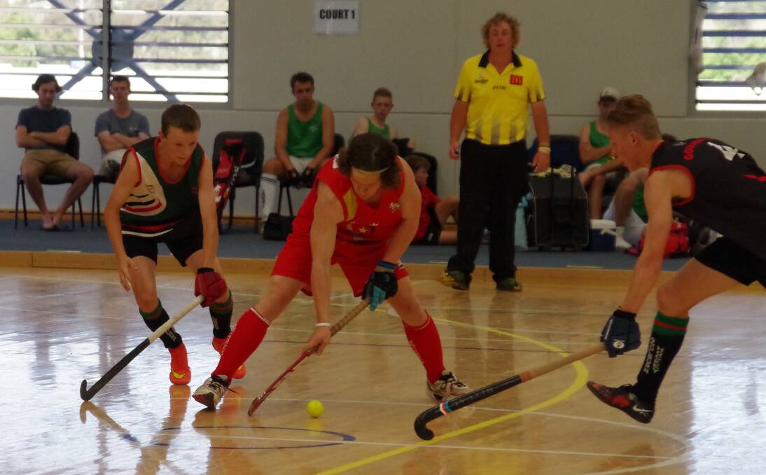 BIG HITS: The Goulburn under-18 boys team (in black) tackles an Illawarra player in last month's NSW Indoor Hockey Chamionships held at the Veolia Arena. Photo: Darryl Fernance.