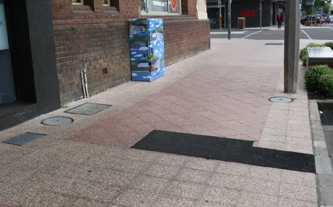 MISMATCH: Telecommunications companies have replaced council paving with black hot mix asphalt after undertaking work in the CBD. Photo supplied. 