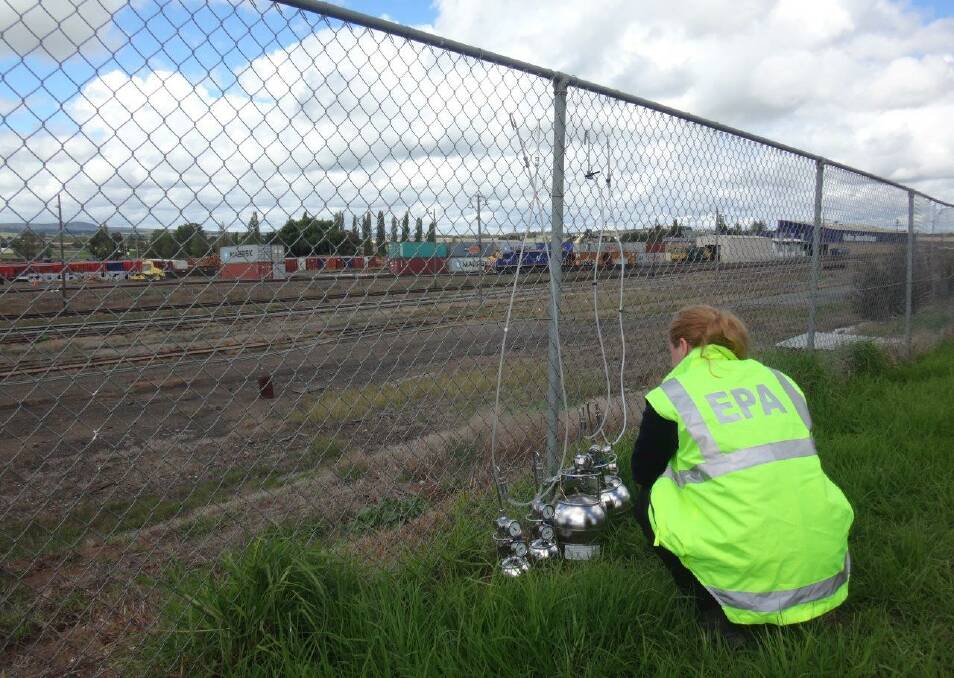 An EPA officer undertaking testing of methyl bromide concentration levels on Sloane Street, near Chicago Freight Rail's timber yard in April. Photo: EPA.