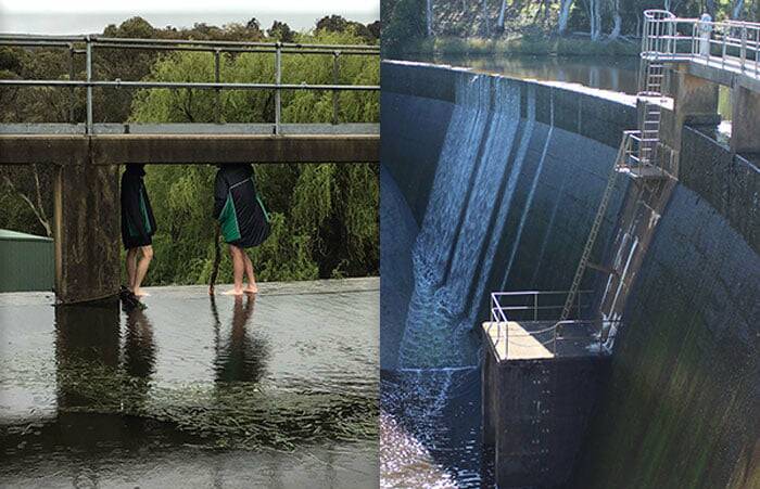 DANGEROUS: Two young people were photographed standing on the edge of the Crookwell dam wall, which has a 12-metre drop. General manager Colleen Worthy has warned people to keep off the structure due to the danger. Photo: Upper Lachlan Shire Council Facebook page.