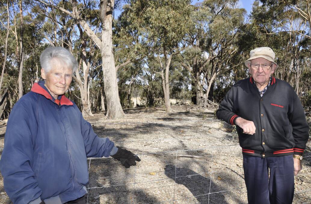 NOT HAPPY: Barbara and Don Riley at the quarry's boundary. The development is behind them and just 350 metres from their home.