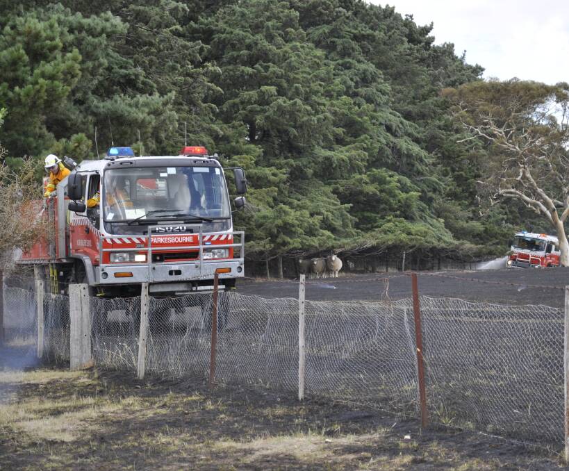 RAPID: Fire came within 50 metres of a house near the Hume Highway at Yarra on Monday. The quick RFS response was instrumental in limiting the outbreak to two hectares. Photo: Louise Thrower.