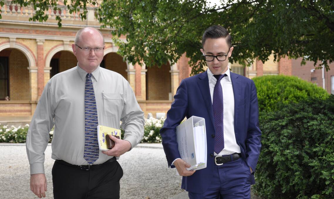 INQUEST: Former Goulburn Mulwaree Council works manager Andrew Palmer leaves Goulburn Courthouse with his legal representative on Wednesday. Mr Palmer's actions are the subject of questions.