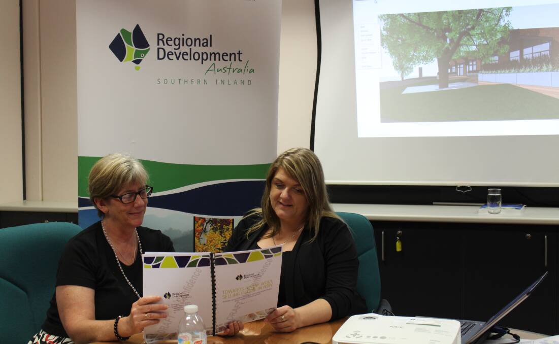 RDASI Maryann Weston communications and project manager and Mareeca Flannery, executive officer discussing an earlier draft report on the viability of wool selling in Goulburn.