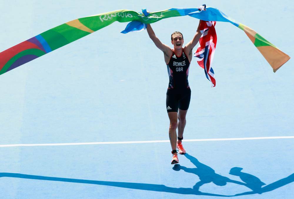 DAY 13: Alistair Brownlee of Great Britain celebrates after crossing the finish line during the Men's Triathlon . Photo: Adam Pretty/Getty Images