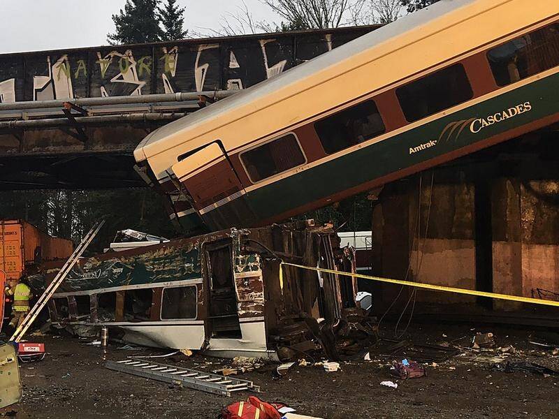 Reports said the Amtrak train car fell from an overpass, landing on a highway outside. Photo: AAP
