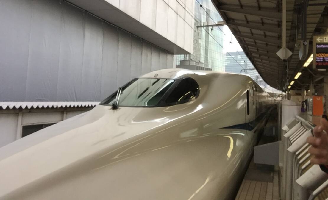 SLEEK MACHINE: A Shinkansen pulling into Tokyo station. Note the areodynamic design. It resembles a giant white snake as it glides in. Photo David Cole.