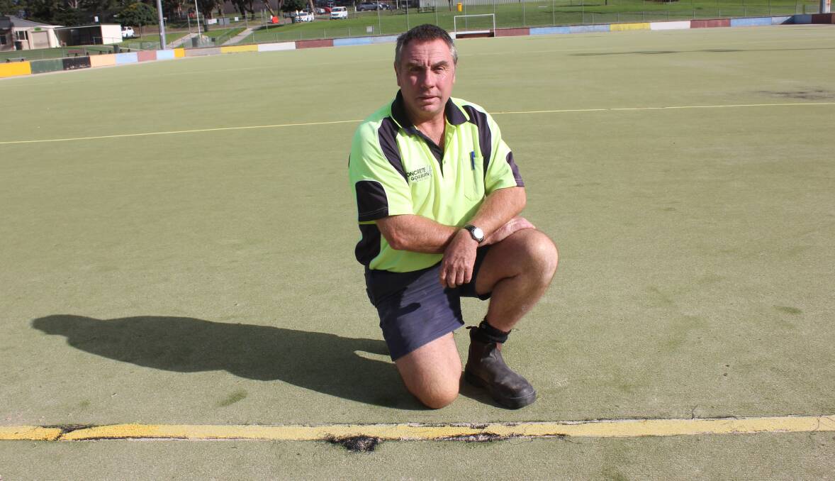 DAMAGE: Cr Andrew Banfield surveys one of the damaged areas of the hockey fields on Thursday. 