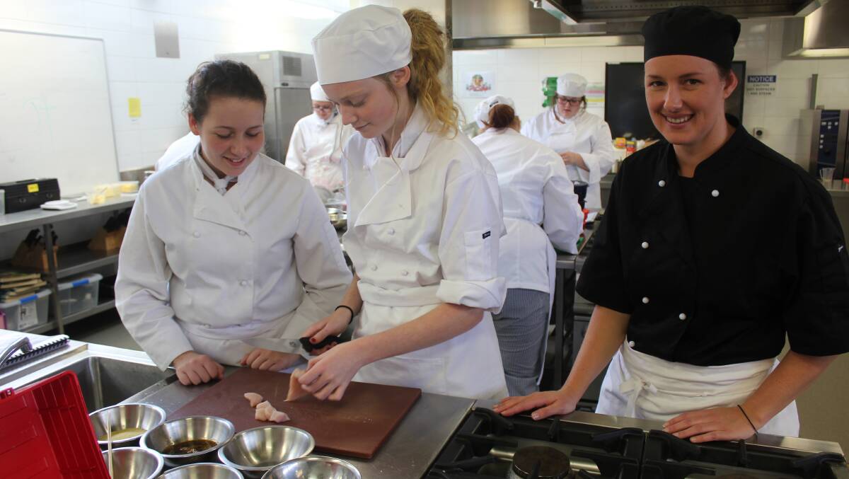 PREPARATION: Practicing food preparation for the Mulwaree on Show were Year 11 Hospitality students Lucy Jubb and Sarah McKavanagh with teacher Megan Burgess. 